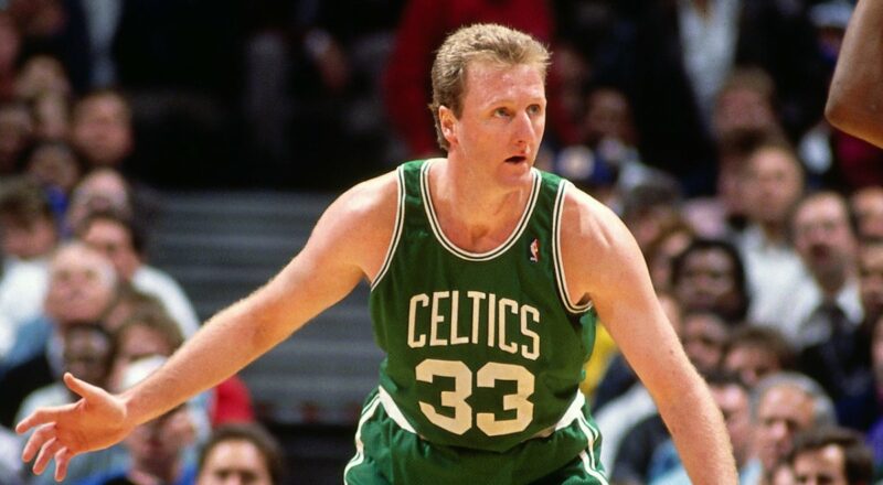 Larry Bird, the basketball legend, pictured on the court, representing the financial success and career achievements discussed in the blog about his net worth