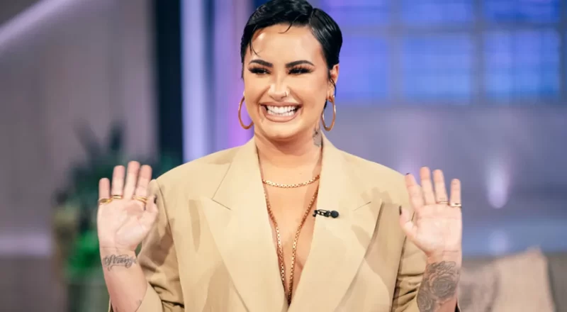 Demi Lovato, the music icon and mental health advocate, pictured on stage, representing the financial success and advocacy efforts discussed in the blog about her net worth