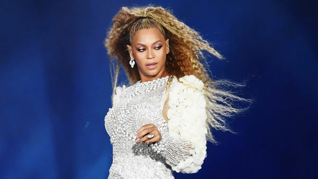 Beyoncé, the music sensation, captured on stage, symbolizing the financial success and career milestones discussed in the blog about her net worth