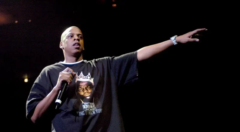 Jay-Z, the cultural icon, pictured on stage, representing the financial success and career achievements discussed in the blog about his net worth.