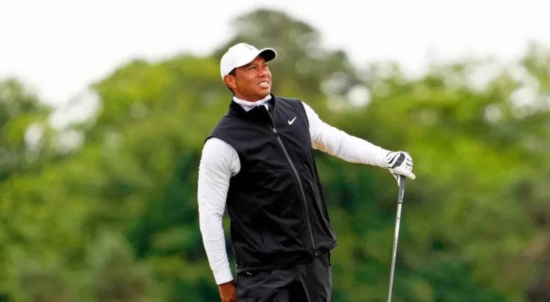 Tiger Woods, the golfing icon, pictured on the course, symbolizes the financial success and career achievements discussed in the blog about his updated net worth.